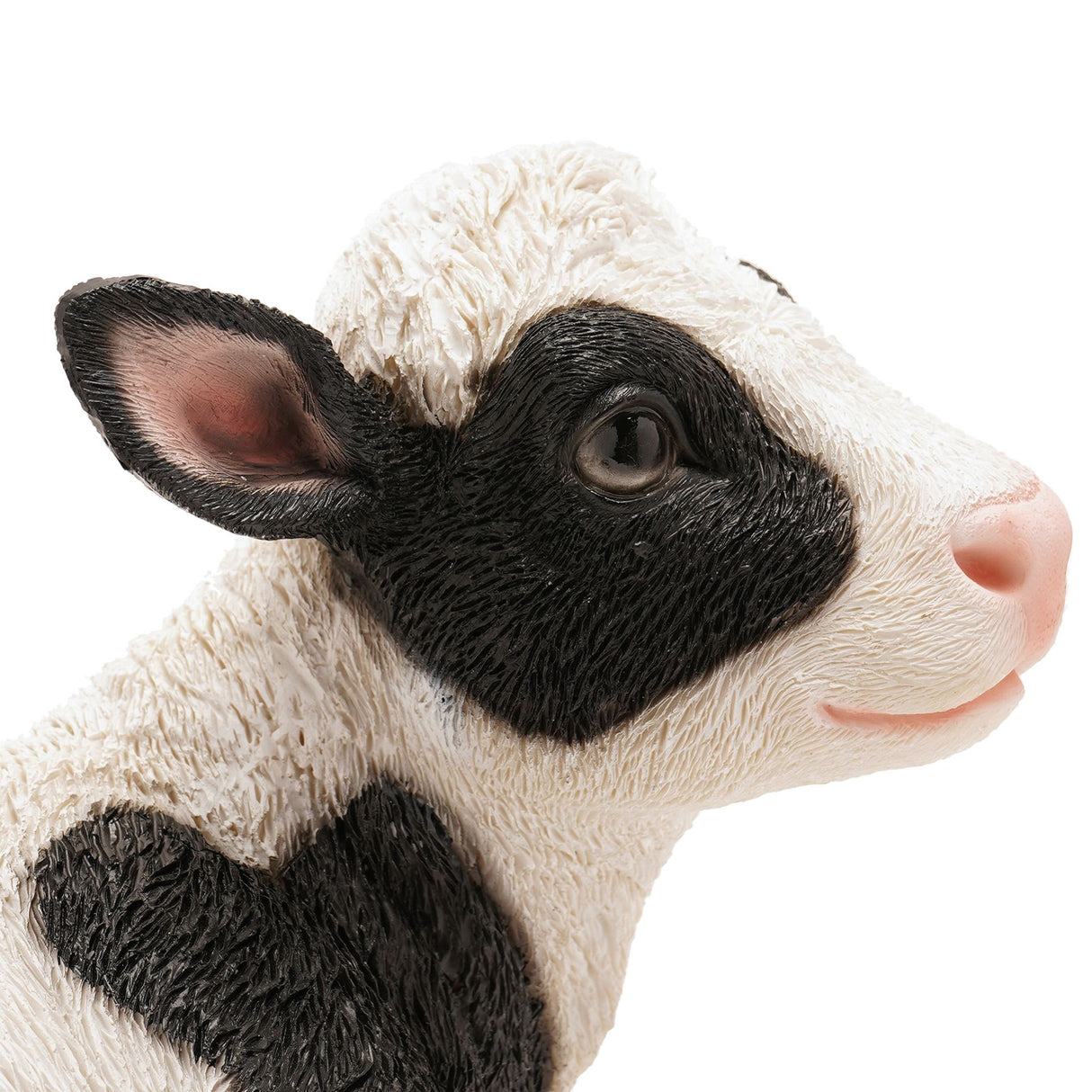 Naturecraft sitting cow figurine 20.5cm with black and white painted resin finish, realistic facial details and pink nose, displayed against white background