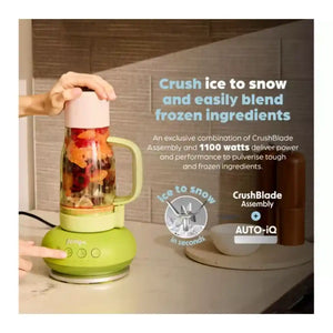 Ninja BlendBOSS lime green tumbler blender with pink lid containing red fruits and vegetables, demonstrating ice crushing capability with text overlay describing 1100 watts power and CrushBlade Assembly technology for frozen ingredients