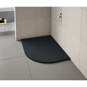 Black curved quadrant shower tray installed in modern bathroom with beige tiled walls and grey floor tiles