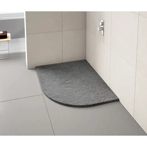 Grey slate effect quadrant shower tray installed in modern bathroom with white tiled walls and chrome shower valve