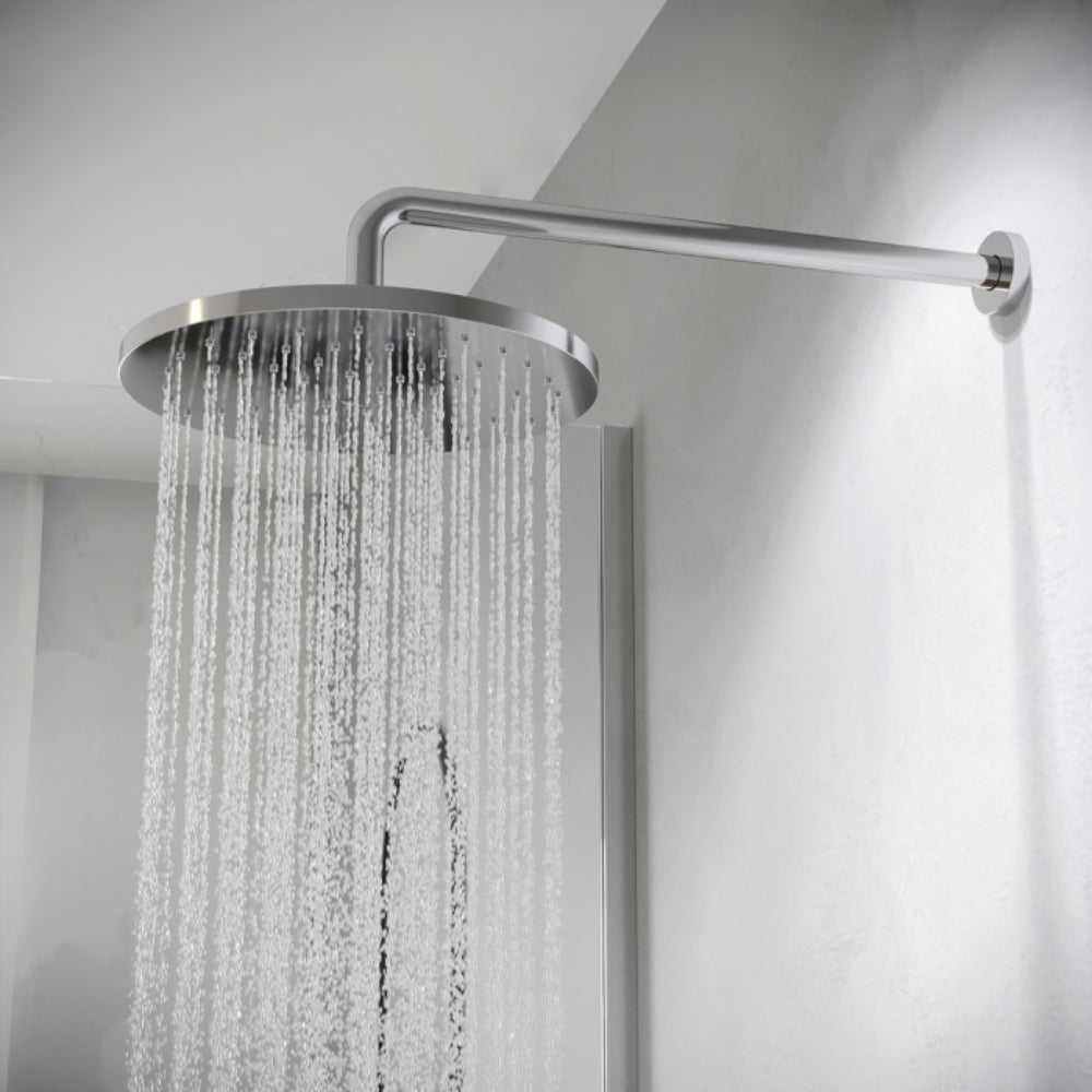 Chrome rainfall showerhead with water spray mounted on angled arm against white bathroom wall, modern minimalist design