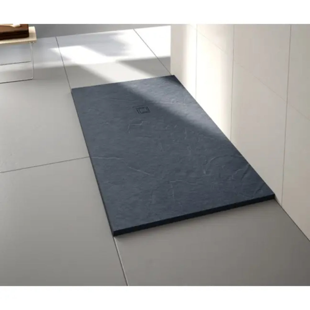Modern dark grey slate-effect rectangular shower tray installed in white tiled bathroom with integrated drain and contemporary minimalist design