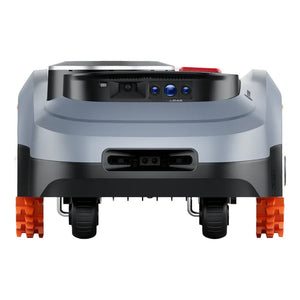 Front view of Segway Navimow i210 robotic lawn mower with white and black body, orange treaded tracks, LiDAR sensor dome on top, and blue optical sensors on the black upper panel