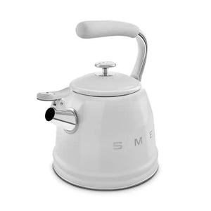 White Smeg 50s style stovetop whistling kettle with stainless steel accents, curved handle, and domed lid featuring the SMEG logo