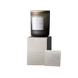 Dark glass candle with 'Calm' label on a white background