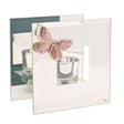 Decorative butterfly with a candle holder on a mirrored surface