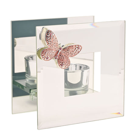 Decorative butterfly with a candle holder on a mirrored surface