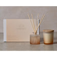 Serenity Breathe diffuser set with a candle and reeds on a neutral background