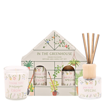 Gift set with candle, diffuser, and decorative items featuring gardening-themed designs.