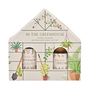 In the Greenhouse Orange Blossom diffuser and candle gift set in house-shaped packaging featuring illustrated potted plants, hanging flowers, and gardening tools with thank you messages on cream background