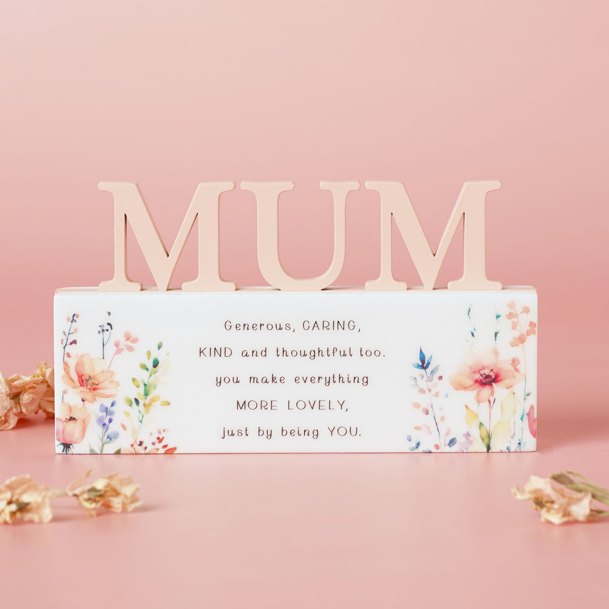 Decorative sign with 'MUM' on a pink background