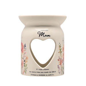 Cream ceramic wax melt burner with heart-shaped cutout, decorated with watercolor flowers in pink, orange and purple, labeled "Loveliest Mum" with sentimental text about smiles and gardens