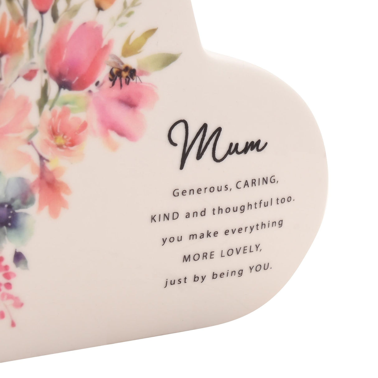 Ceramic heart-shaped plaque with floral design featuring pink and coral flowers with a bee, text reading "Mum" in script followed by "Generous, CARING, KIND and thoughtful too. you make everything MORE LOVELY, just by being YOU" in black text on a cream background