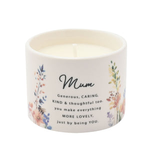 Ceramic scented candle with cream-colored container featuring watercolor floral botanical designs in soft blues, pinks and greens, with black text reading Mum and a heartfelt message about being generous, caring, kind and thoughtful