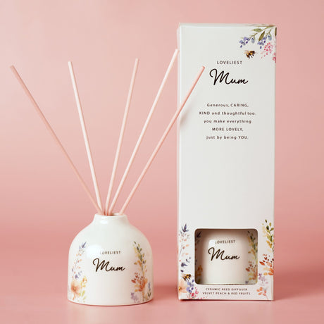 Reed diffuser set with 'Loveliest Mum' packaging on a pink background