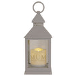 Gray lantern with a candle inside displaying a message in memory of 'Mum'.