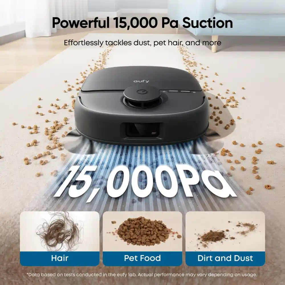 Eufy Omni C28 black robot vacuum cleaner demonstrating 15000 Pa suction power on light carpet with scattered pet food, hair and dust particles, showing cleaning capabilities for pet hair, pet food debris and dirt