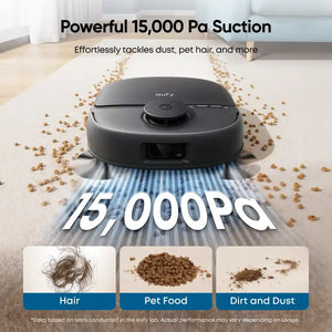 Eufy Omni C28 black robot vacuum cleaner demonstrating 15000 Pa suction power on light carpet with scattered pet food, hair and dust particles, showing cleaning capabilities for pet hair, pet food debris and dirt
