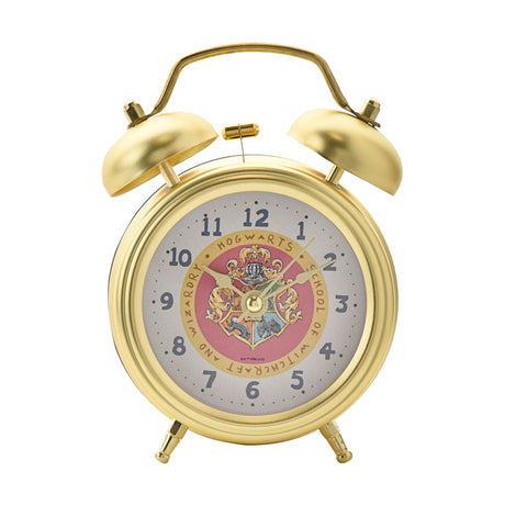 Gold alarm clock with Hogwarts crest on a white background