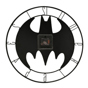 Batman symbol metal wall clock with black bat emblem on white face, roman numerals on outer ring, visible clock mechanism in center, and decorative scalloped border design