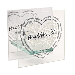 Clear glass square tealight holder with Mum script and heart design surrounded by inspirational words including Love Caring Kindness and Always There in black text, featuring decorative white heart pattern and soft green watercolor accent at base