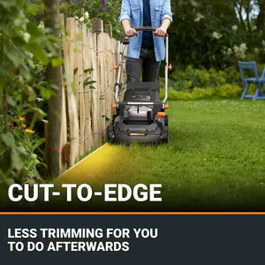 Person operating Worx WG745E 40V cordless lawnmower with cut-to-edge feature along wooden garden fence, demonstrating neat grass trimming capability with yellow cutting line visible on green lawn